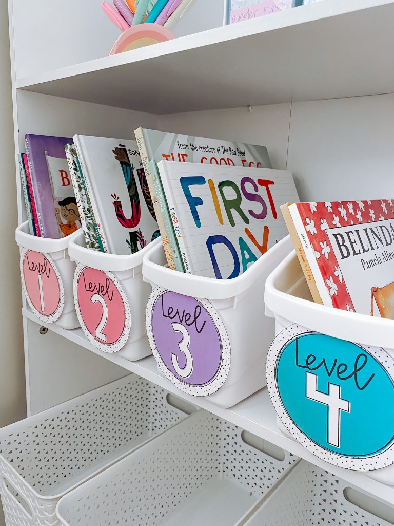 Classroom cubbies can hold reading materials like these four white tubs that are holding books. Each tub has a label - level 1, level 2, level 3, and level 4.