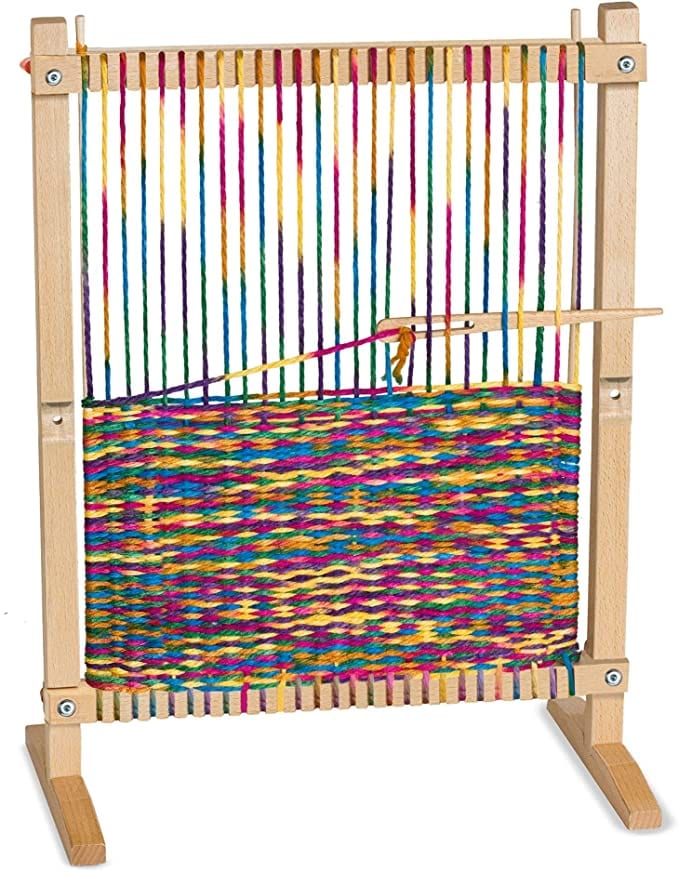 Colorful yarn woven into a wooden loom