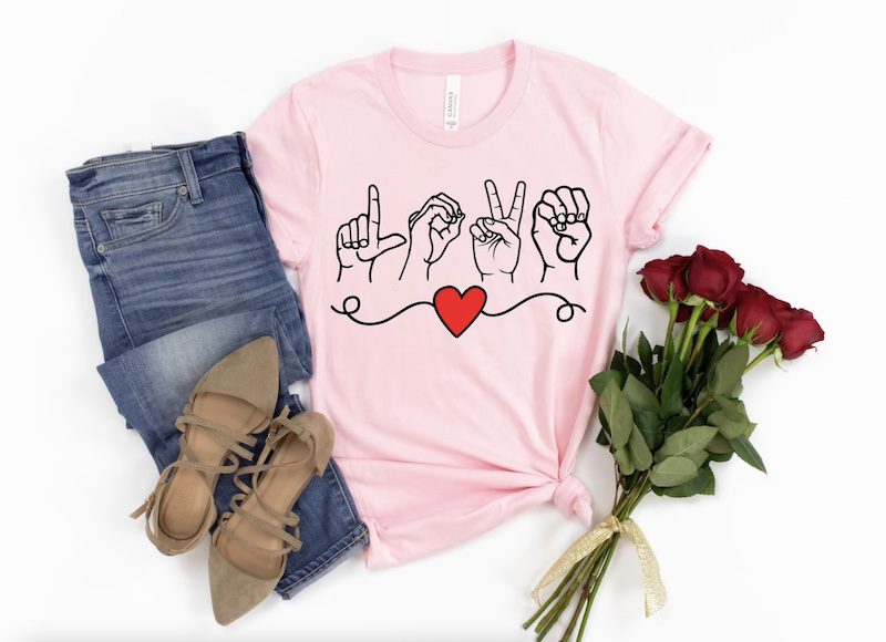 Light pink shirt with 'love' spelled out in sign language