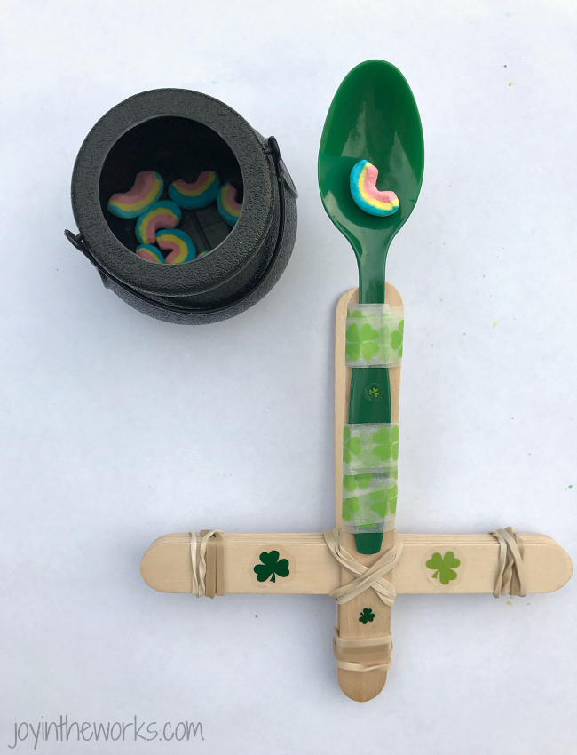 DIY catapult made from craft sticks, rubber bands and a plastic spoon, as an example of St. Patrick's Day activities 