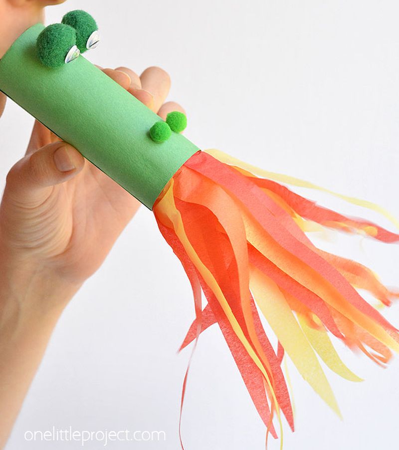 Lunar New Year Crafts: Fire Breathing Dragon Child blowing through a toilet paper tube made to look like a fire-breathing dragon