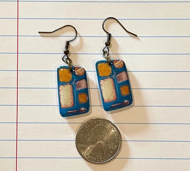 Dangle earrings designed to look like old school cafeteria trays with lunches on them.
