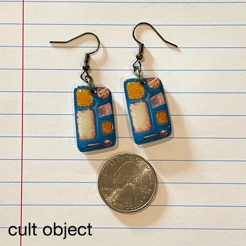 Dangle earrings are designed to look like old school cafeteria trays with lunches on them.