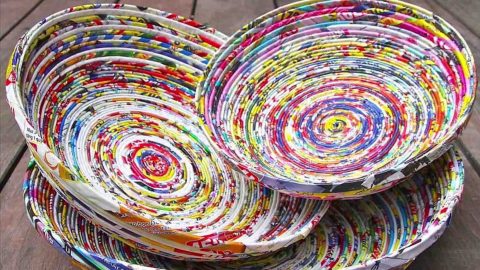 Two bright bowls are made from rolled up magazine twists glued together.