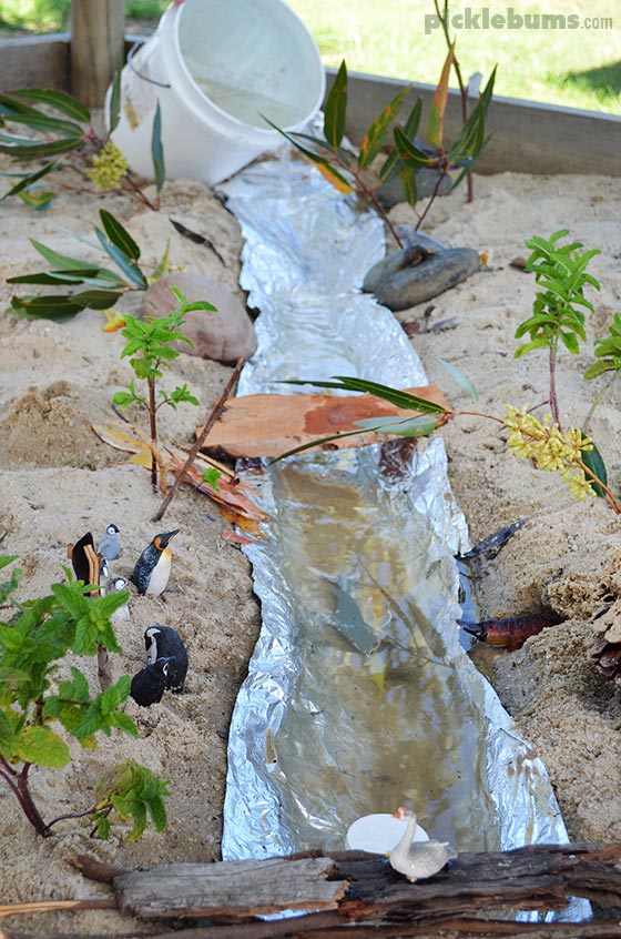 a river made with foil on a dirt path and water 