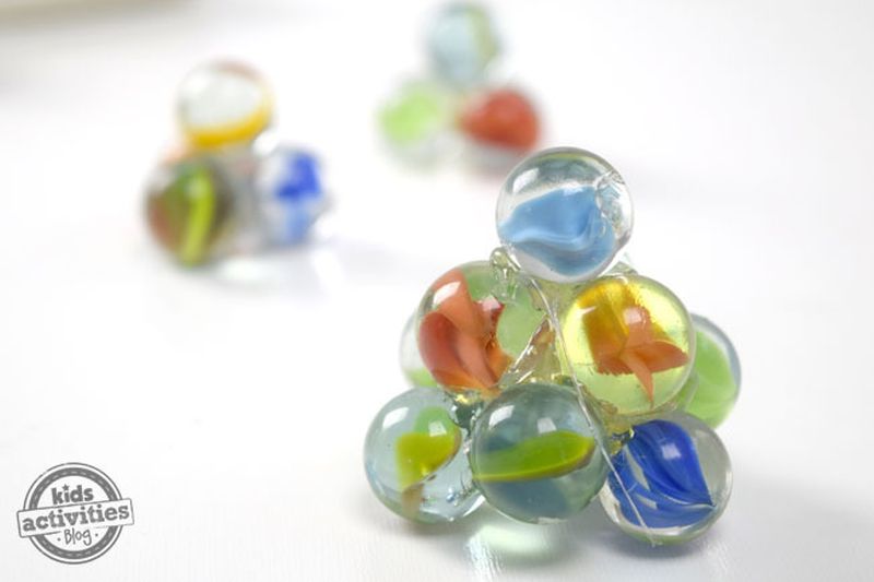 Colorful marbles glued together in several pyramidal shapes