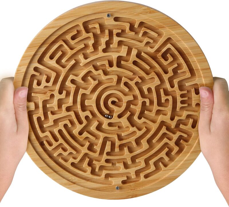 A wooden circle is carved into a maze in this example of marble games.