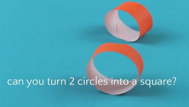 Two orange loops made of strips of paper on a blue background. Text reads Can you turn 2 circles into a square?