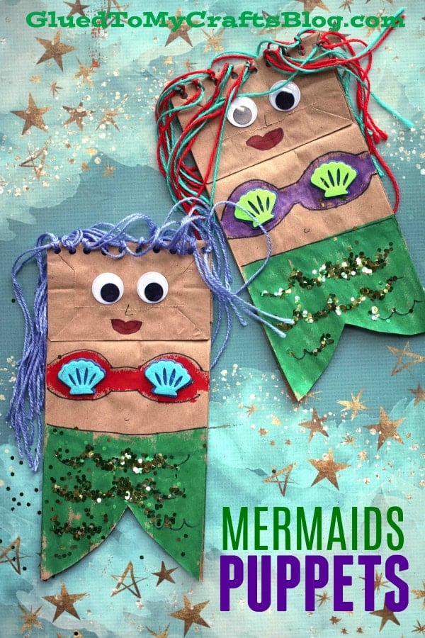 Two paper bags are transformed into mermaid puppets with paint, string and shell buttons