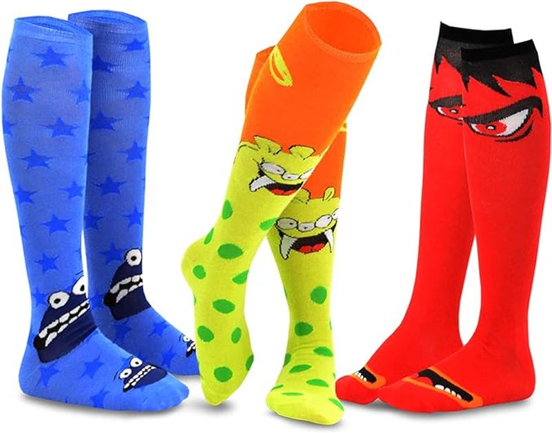 Three colorful pairs of knee-high socks with monster eyes and faces