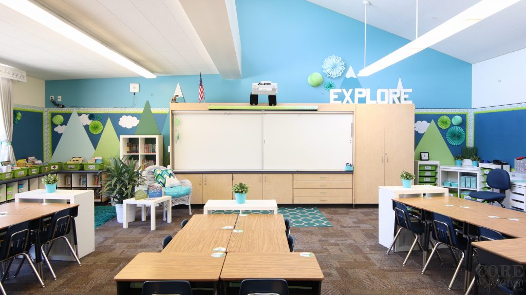 Calming classroom theme of mountains. The walls are painted blue and mountains are shown on the walls in green and blue. 