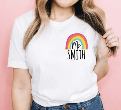 White tshirt with teachers name and a rainbow, as an example of Etsy teacher shirts