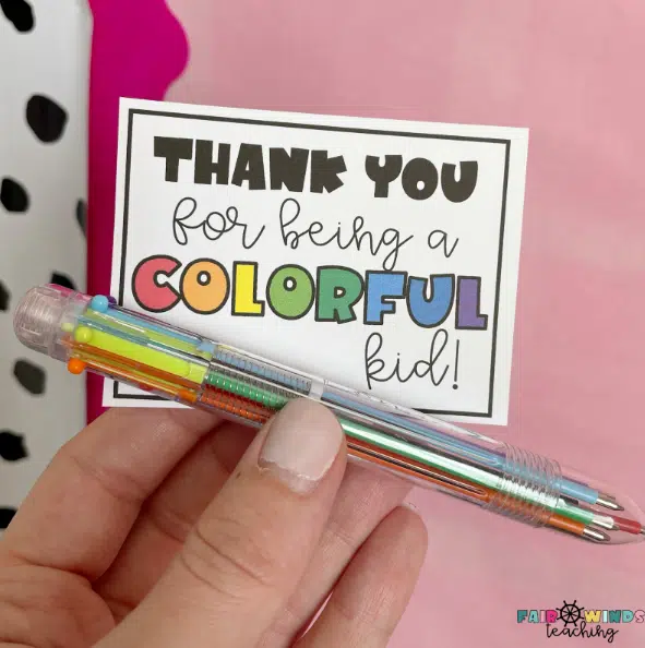 A multi-colored pen with a card that reads "Thank you for being a colorful kid"