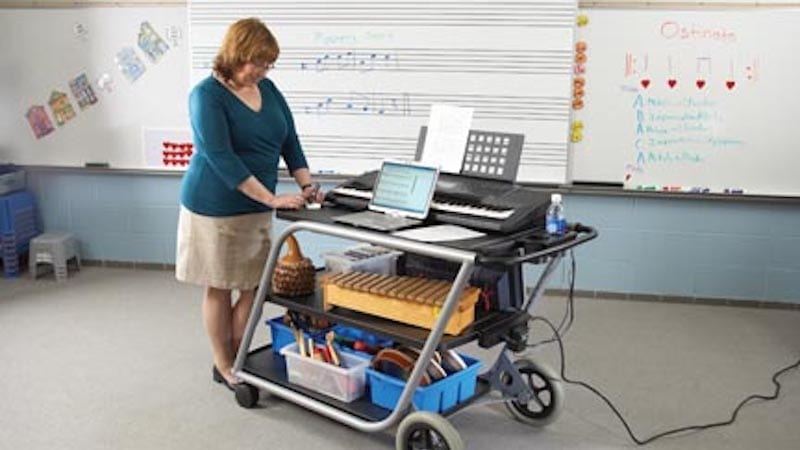 Music teacher with a cart full of supplies