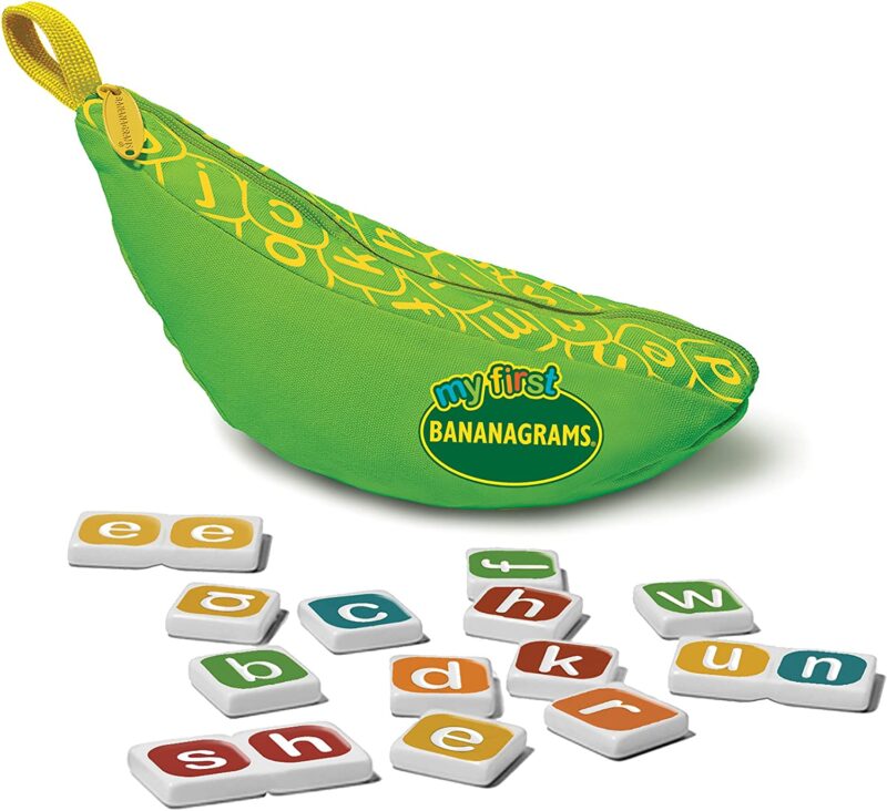 A green bag in the shape of a banana says My first bananagrams. Tiles with different letters in different colors are also shown.