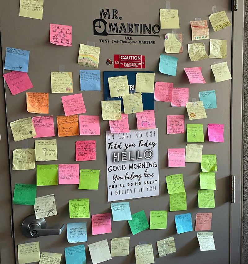 A custodian's office door covered with sticky note thank yous