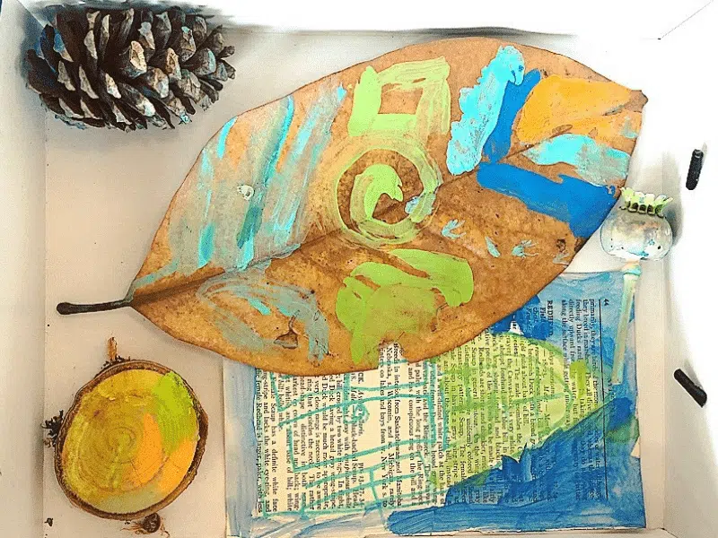 A beautiful collage is made from natural found objects as an example of summer crafts for kids