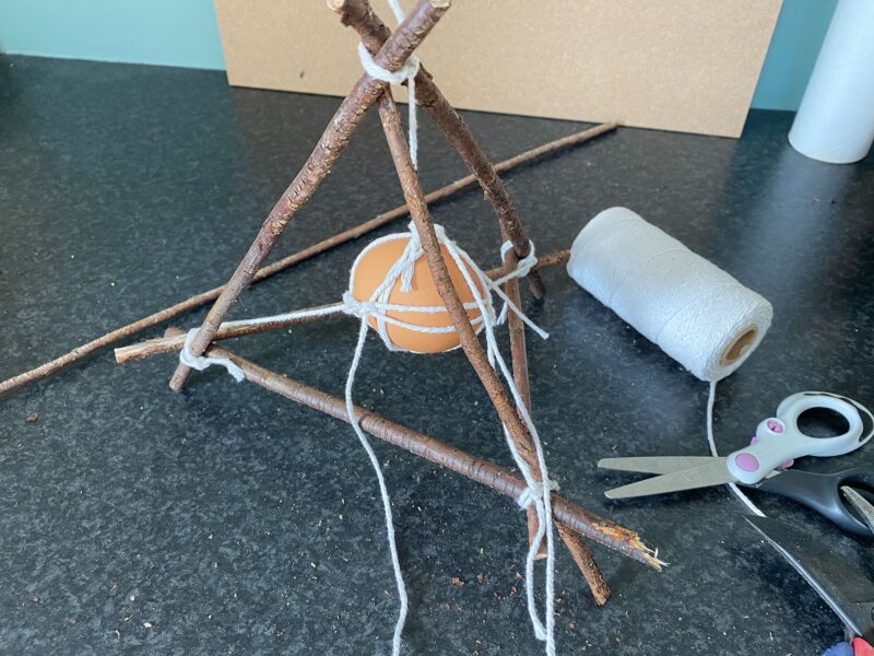 egg drop made with sticks and twine 