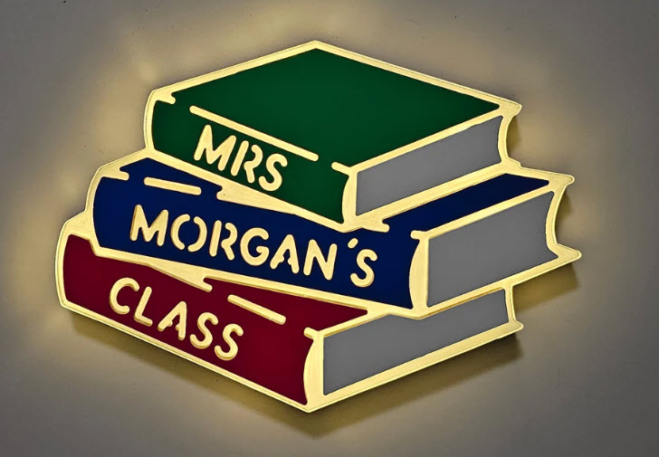 Neon sign in the shape of a stack of books, with text reading Mrs. Morgan's Class