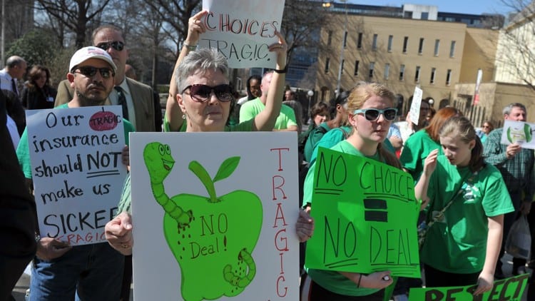 Teachers holding up teacher signs in protest