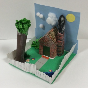 A cottage scene sculpture is shown. (second grade art)