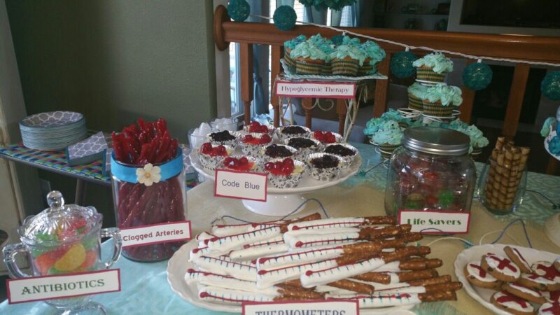 snacks on a table that have a nurse theme. life savers. thermometers made out of pretzels. 