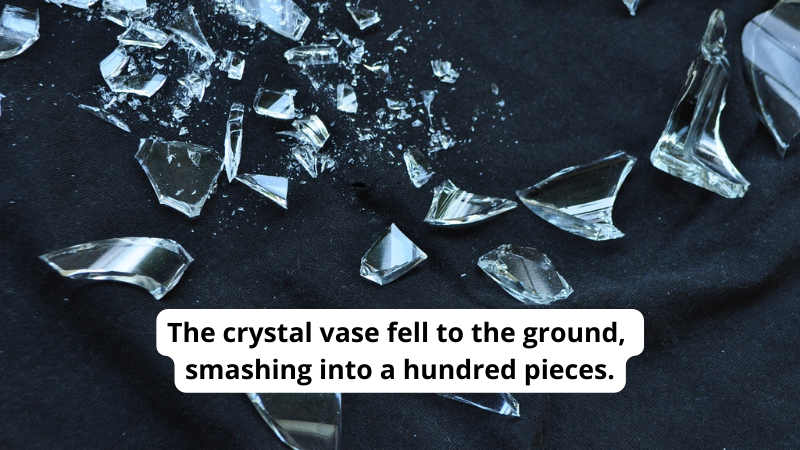 Pieces of broken glass on a black background. Text reads The crystal vase fell to the ground, smashing into a hundred pieces.