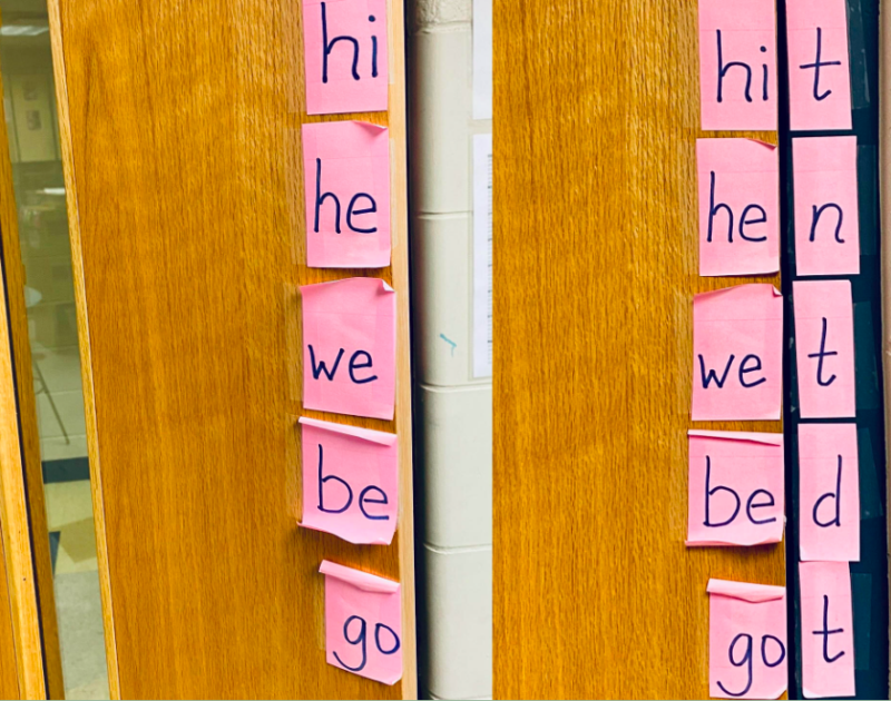 Classroom door with letter sticky notes arranged to teach open and closed syllable types