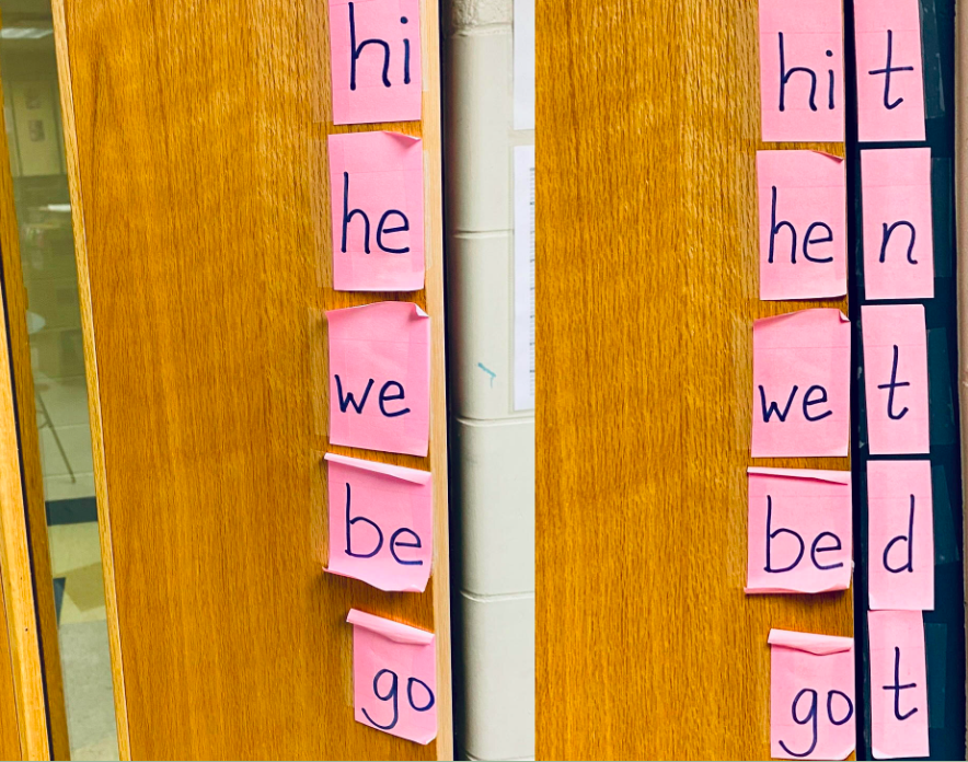 Classroom door with letter sticky notes arranged to teach open and closed syllables