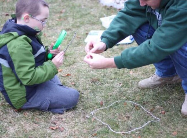 Outdoor science activities involve getting outside like this one where kids are shown examining the flora and fauna in one square foot of ground 