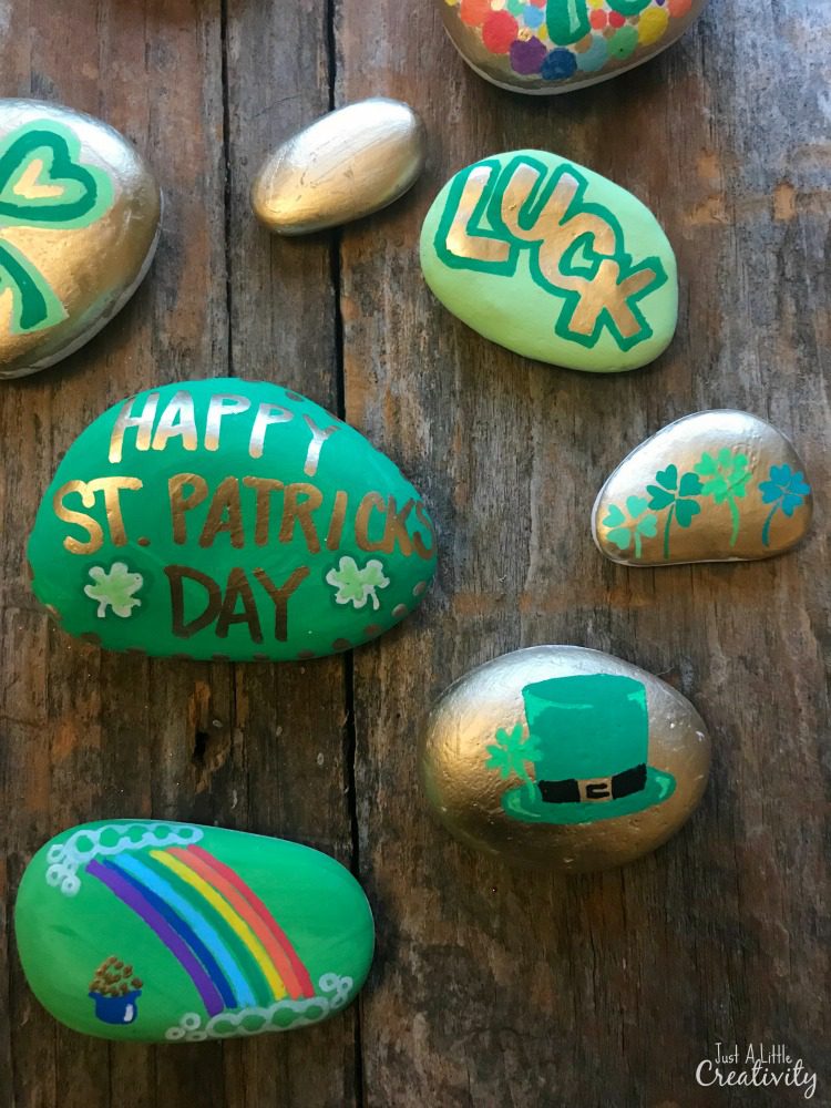 Multiple rocks are shown painted for St. Patrick's Day (St. Patrick's Day crafts for kids)