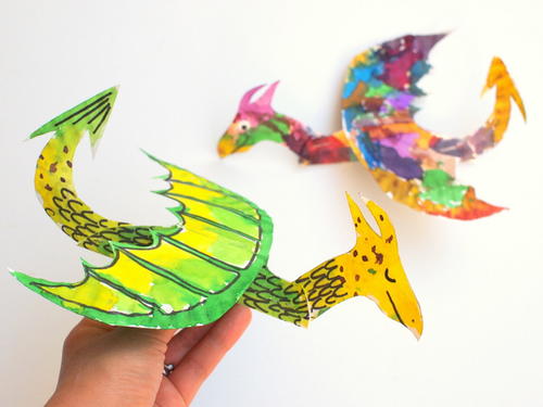 Two dragons are painted bright colors and made from paper plates.