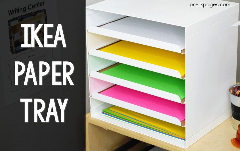 A white letter tray with 6 shelves each containing different colored paper. 