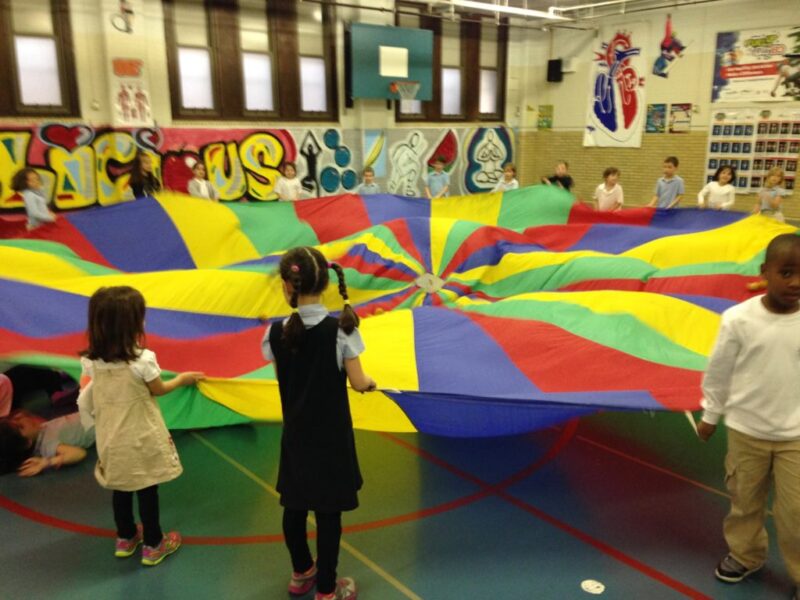 kids holding a parachute for parachute games 
