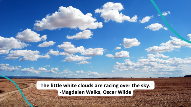 Fluffy clouds against a blue sky, over a golden plain. Text reads ""The little white clouds are racing over the sky ..." -Magdalen Walks by Oscar Wilde"