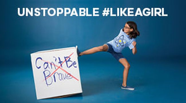 Girl kicking a sign that says "Can't be brave". Text reads "Unstoppable #likeagirl"
