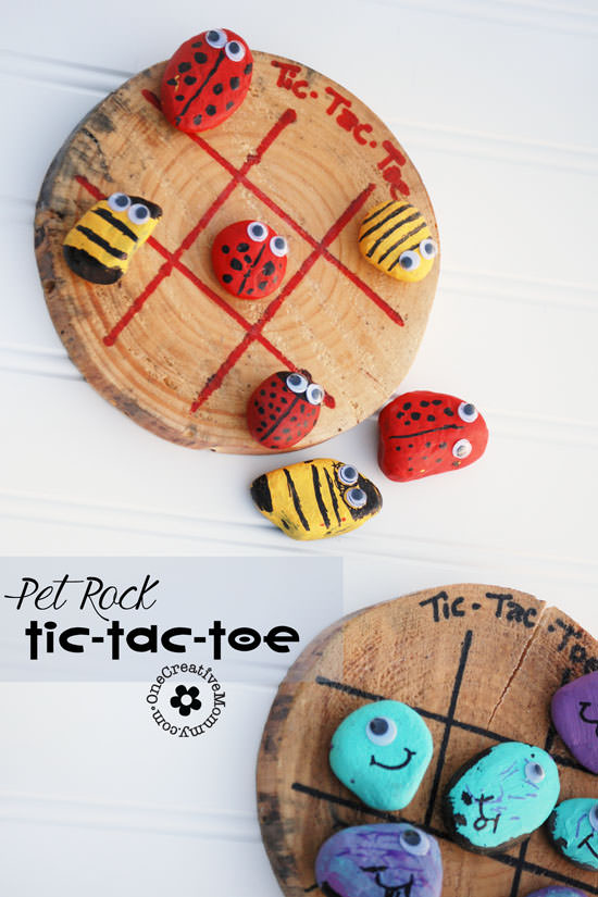 Tic Tac Toe boards are painted onto wood stumps. Rocks are painted in two opposing designs to act as Xs and Os.