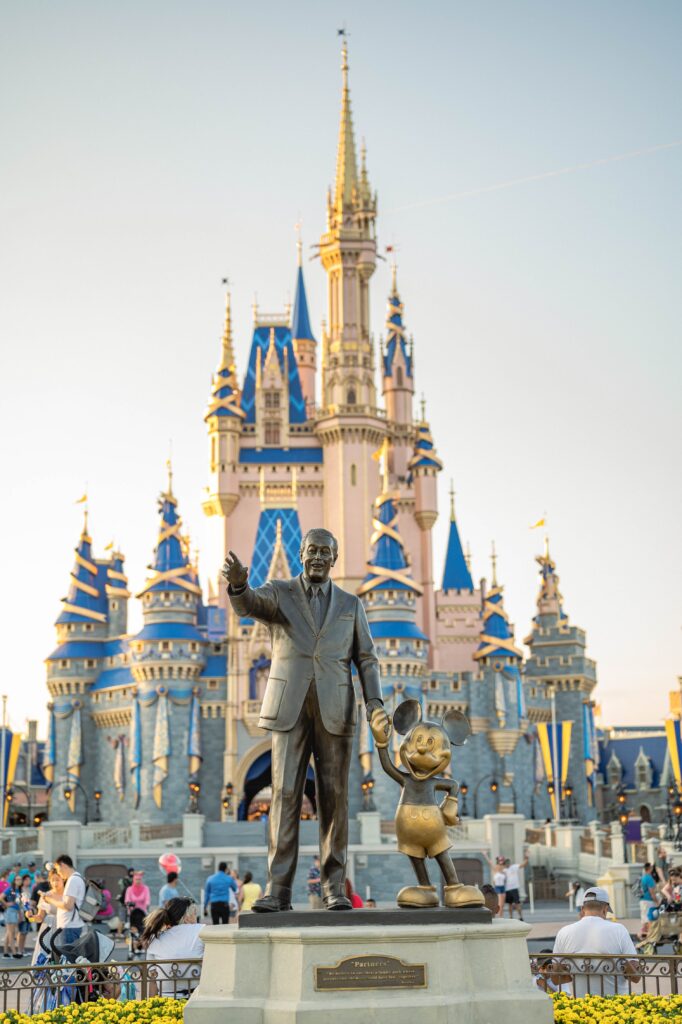 Image of disney statue in front of the disney castle 