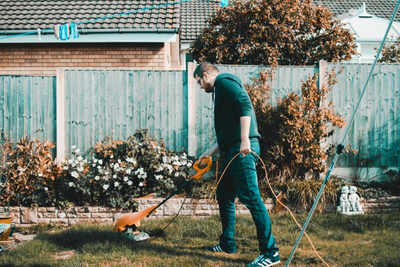 man doing yard work summer job idea for teachers 