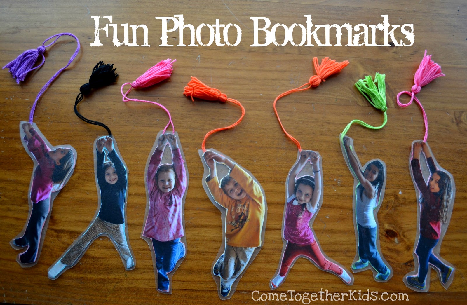 Bookmarks are made from photos of kids with their arms oustretched. Tassels are attached to the top.
