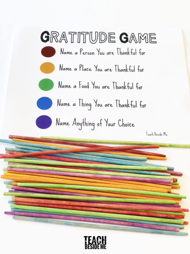 Gratitude activities for kids include this piece of paper that has color coded gratitude prompts that match up with colors of the pile of pickup sticks.