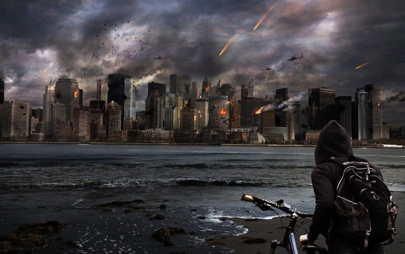 A boy stands with his bicycle watching as bombs rain down on a city skyline (Picture Writing Prompts)