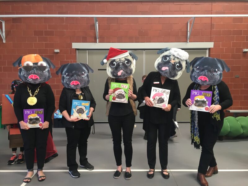 Five teachers are shown wearing pug masks and holding different Pig the Pug books.