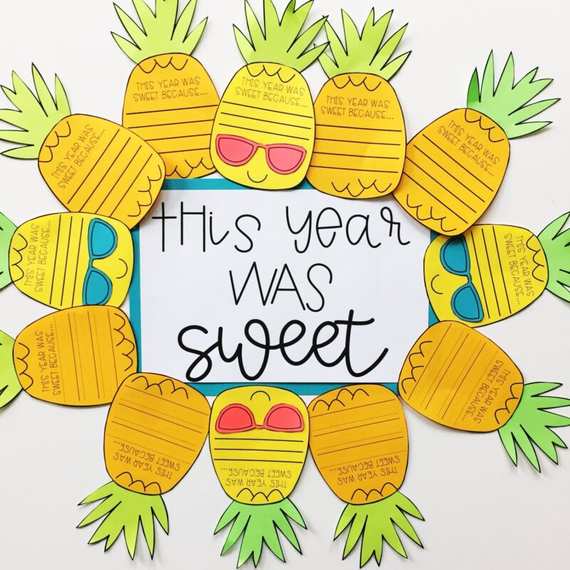 Pineapples line the outside of the bulletin board. They have lines for a writing prompt on them and some are wearing sunglasses. The middle says this year was sweet (summer bulletin board ideas)