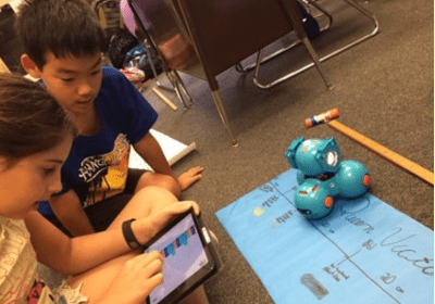 young students using coding and robotics