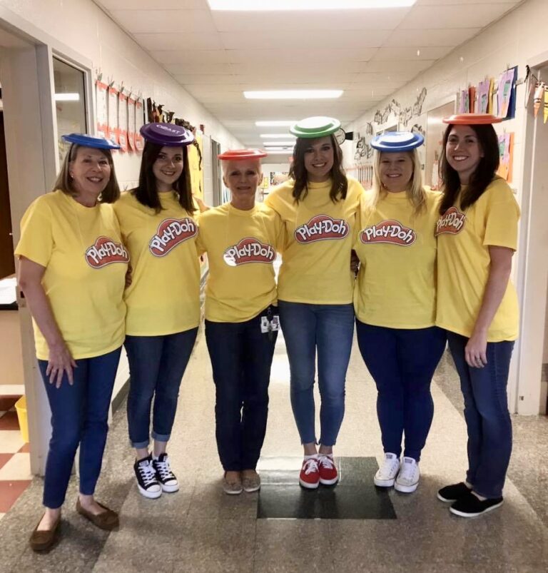 Six teachers are dressed as play-doh containers wearing yellow shirts and different colored frisbees on their head as the lids.