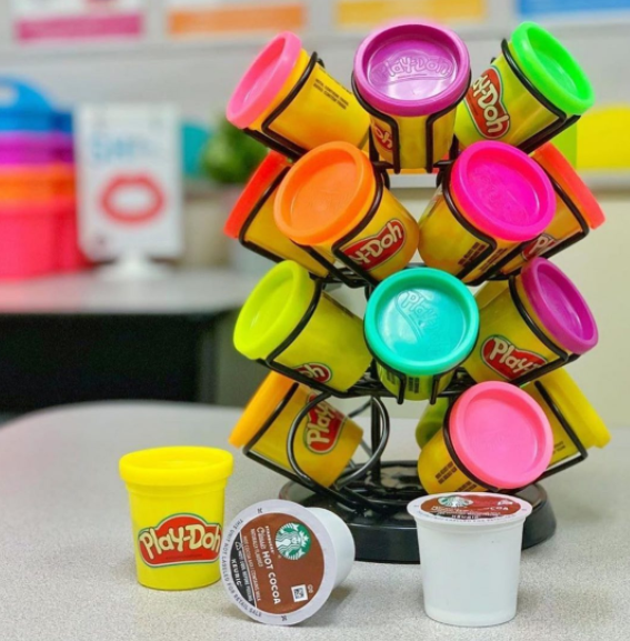 A k-cup organizer is used to house different colored play-doh containers.
