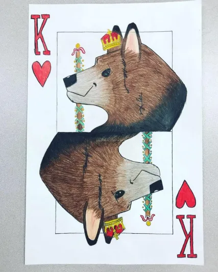 A hand drawn playing card has a wolf instead of the usual King design.
