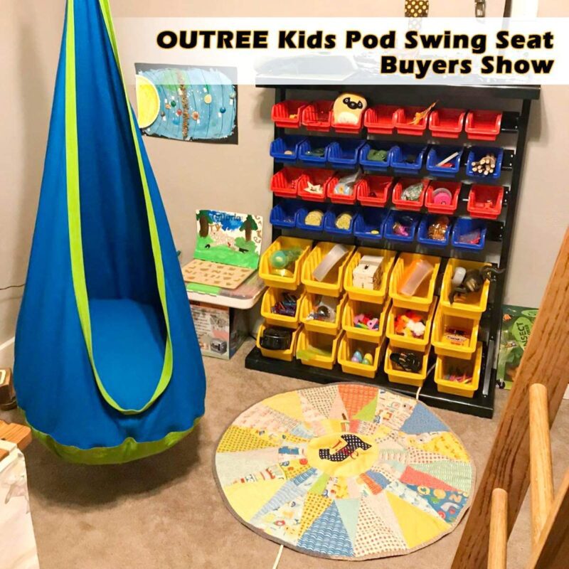 A blue pod style swing hangs in a classroom/playroom (sensory toys)