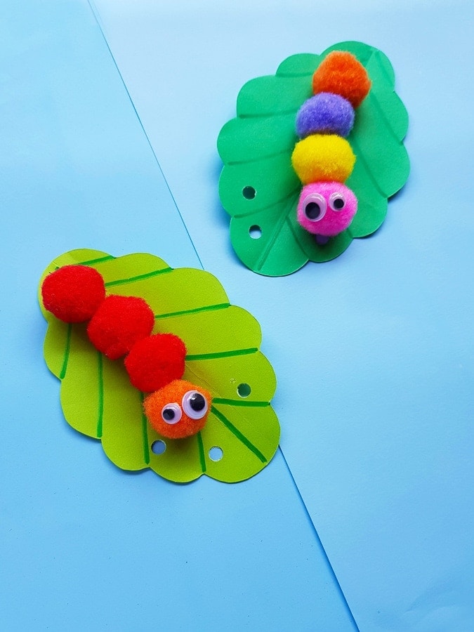 Caterpillars are made from pom poms on green cardstock.